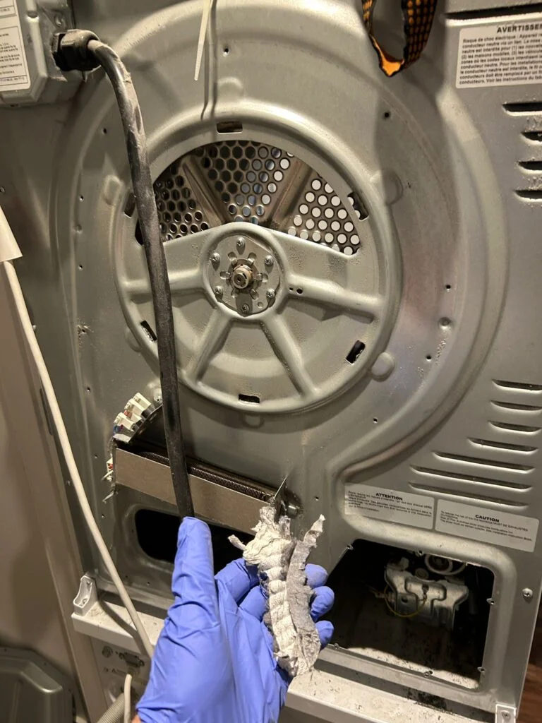 Dryer heating element area cleaned of lint during service